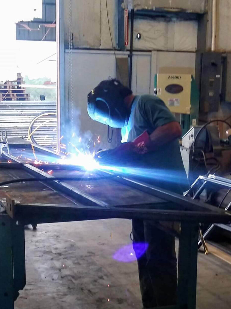 A welder welding a frame